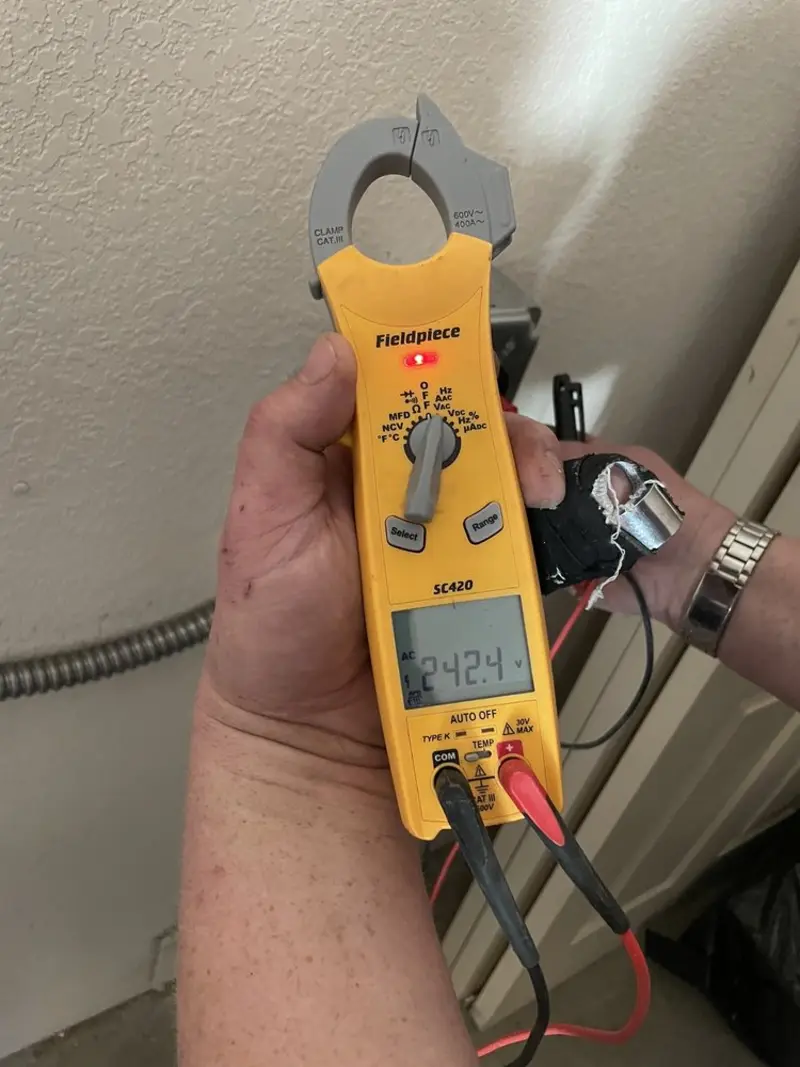 Voltage testing with clamp meter during Recessed Lighting Installation in Wendell